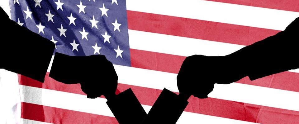 silhouette of two hands casting ballots